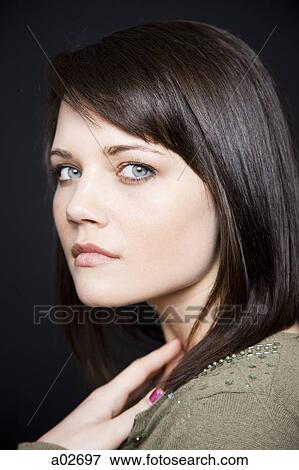 Studio portrait of young woman View Large Photo Image Stock Photo - Studio portrait of young woman. Fotosearch