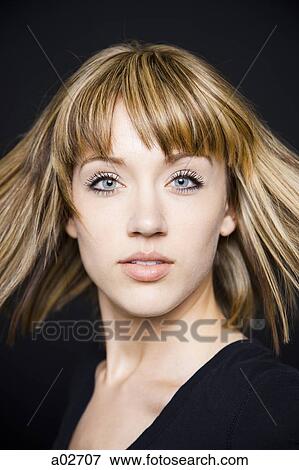 Stock Photo - Studio portrait of young woman. Fotosearch