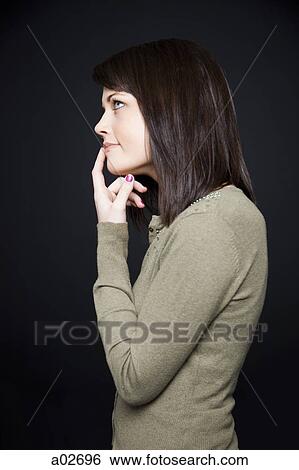 Studio portrait of young woman View Large Photo Image Stock Photograph - Studio portrait of young woman. Fotosearch
