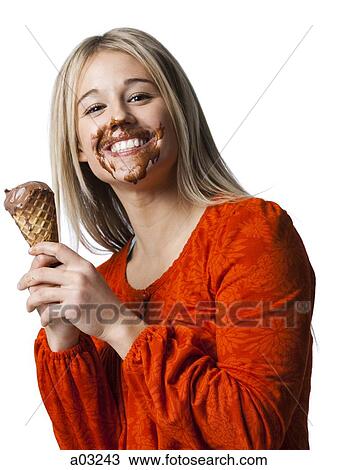 Studio portrait of young woman with ice cream on face View Large Photo Image Stock Image - Studio portrait of young woman with ice cream on face. Fotosearch