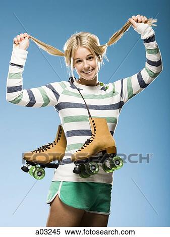 Studio portrait of young woman with roller skates View Large Photo Image Stock Photography - Studio portrait of young woman with roller skates. Fotosearch