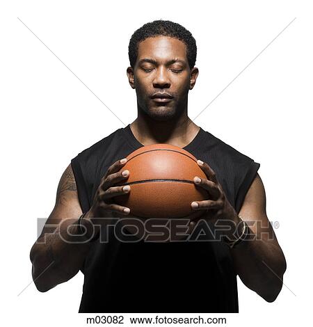 Studio shot of basketball player holding ball View Large Photo Image Stock Image - Studio shot of basketball player holding ball. Fotosearch