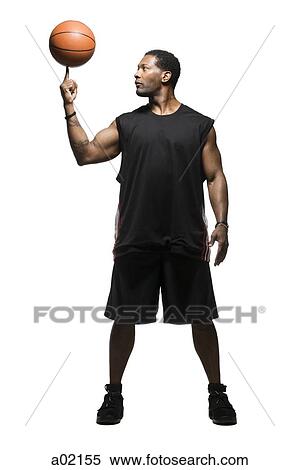 Studio shot of basketball player balancing ball on finger View Large Photo Image Stock Photography - Studio shot of basketball player balancing ball on finger. Fotosearch