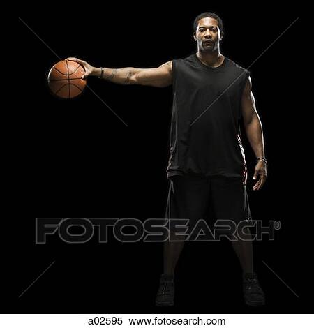 Studio shot of basketball player holding ball View Large Photo Image Stock Photography - Studio shot of basketball player holding ball. Fotosearch