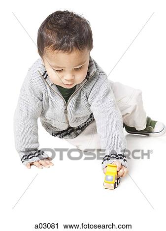 Studio shot of boy (18-23 months) playing with toy car View Large Photo Image Stock Image - Studio shot of boy (18-23 months) playing with toy car. Fotosearch