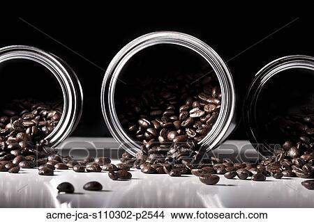 Studio shot of coffee beans spilling from tins View Large Photo Image Picture - Studio shot of coffee beans spilling from tins. Fotosearch