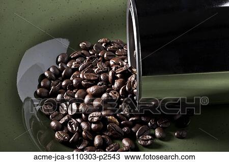 Stock Image - Studio shot of coffee beans spilling from tin. Fotosearch