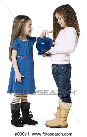 Studio shot of girl (4-5) inserting money to piggy bank held by friend (6-7) View Large Photo Image Stock Image - Studio shot of girl (4-5) inserting money to piggy bank held by friend (6-7). Fotosearch