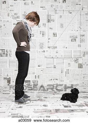 Studio shot of young woman scolding dog View Large Photo Image Stock Photo - Studio shot of young woman scolding dog. Fotosearch