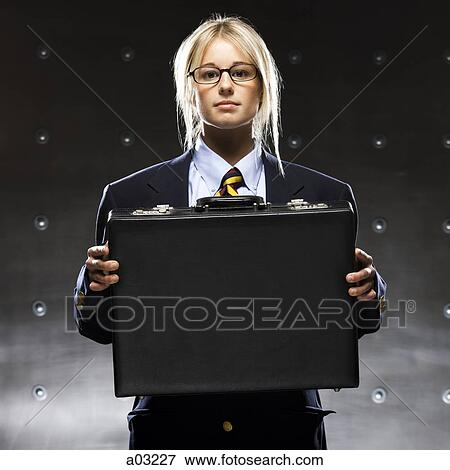 Successful businesswoman holding suitcase, portrait View Large Photo Image Stock Photo - Successful businesswoman holding suitcase, portrait. Fotosearch