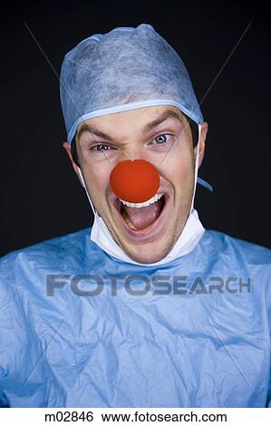 Stock Photograph - surgeon wearing a creepy clown nose. Fotosearch