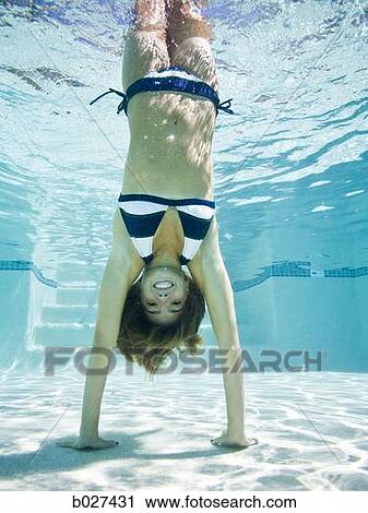 teenage girl doing a handstand under water View Large Photo Image Stock Image - teenage girl doing a handstand under water. Fotosearch