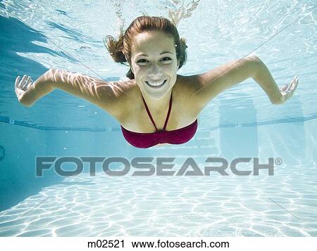 teenage girl in a bathing suit swimming in a pool View Large Photo Image Stock Image - teenage girl in a bathing suit swimming in a pool. Fotosearch