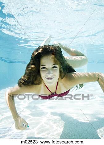 teenage girl in a bathing suit swimming in a pool View Large Photo Image Stock Image - teenage girl in a bathing suit swimming in a pool. Fotosearch