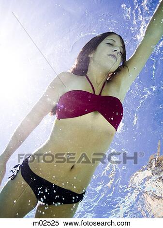 Stock Photography - teenage girl in a bathing suit swimming in a pool. Fotosearch
