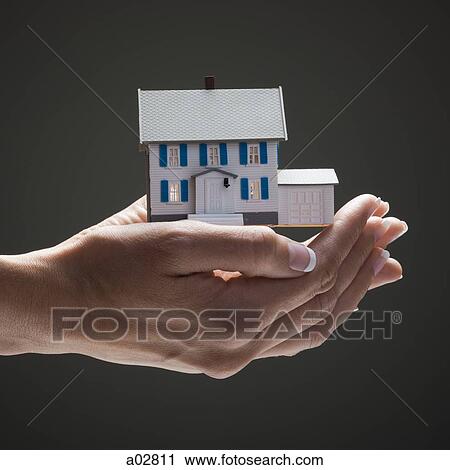Toy house in young woman's hands View Large Photo Image Stock Image - Toy house in young woman's hands. Fotosearch