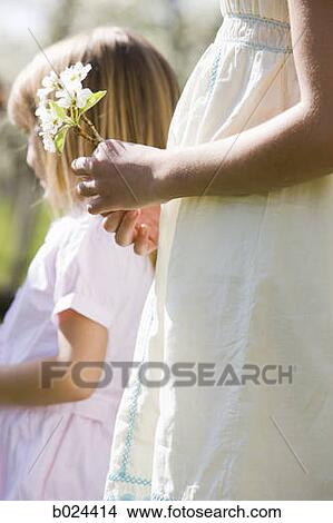 two girls in a blossoming orchard View Large Photo Image Picture - two girls in a blossoming orchard. Fotosearch