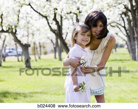 two girls in a blossoming orchard View Large Photo Image Stock Photo - two girls in a blossoming orchard. Fotosearch