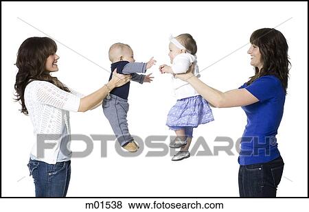 Stock Photo - two mothers holding their babies face to face. Fotosearch