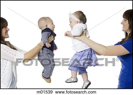 two mothers holding their babies face to face View Large Photo Image Stock Photo - two mothers holding their babies face to face. Fotosearch