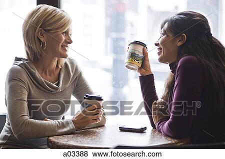 Stock Photo - Two women meeting in cafe. Fotosearch