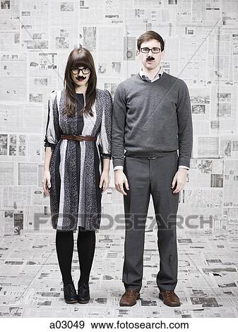 Two young people with fake mustache standing in newspapers covered room, studio shot View Large Photo Image Stock Photo - Two young people with fake mustache standing in newspapers covered room, studio shot. Fotosearch