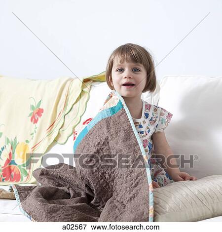USA, California, San Francisco, girl (2-3) sitting on sofa covered with blanket View Large Photo Image Stock Photo - USA, California, San Francisco, girl (2-3) sitting on sofa covered with blanket. Fotosearch