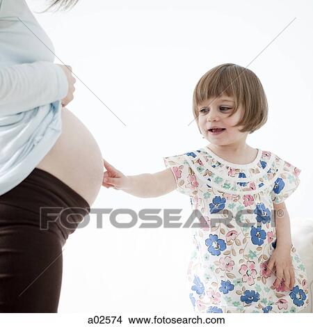 USA, California, San Francisco, little girl (2-3) touching pregnant mother's belly View Large Photo Image Picture - USA, California, San Francisco, little girl (2-3) touching pregnant mother's belly. Fotosearch
