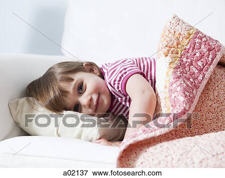 Stock Photo - USA, California, San Francisco, portrait of girl (2-3) lying in bed. Fotosearch