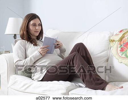 USA, California, San Francisco, pregnant woman lying on sofa and reading View Large Photo Image Stock Photo - USA, California, San Francisco, pregnant woman lying on sofa and reading. Fotosearch