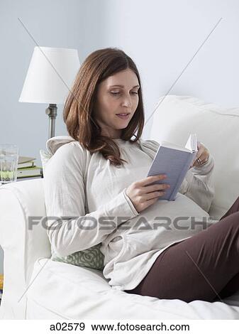 USA, California, San Francisco, pregnant woman lying and reading book on sofa View Large Photo Image Stock Photo - USA, California, San Francisco, pregnant woman lying and reading book on sofa. Fotosearch