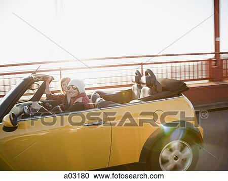 Stock Image - USA, California, San Francisco, yellow car on Golden Gate Bridge. Fotosearch