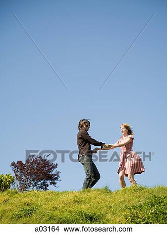 USA, California, San Francisco, young couple holding hands on hill View Large Photo Image Picture - USA, California, San Francisco, young couple holding hands on hill. Fotosearch