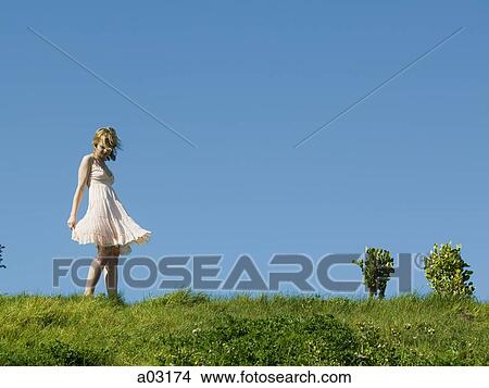 USA, California, San Francisco, young woman standing on grass View Large Photo Image Picture - USA, California, San Francisco, young woman standing on grass. Fotosearch