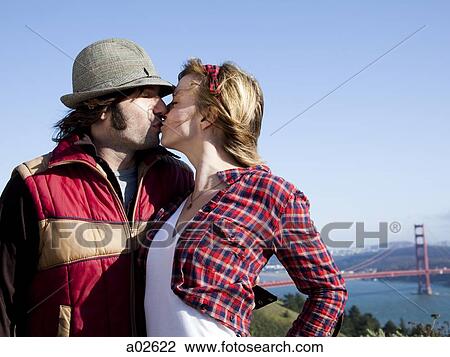 USA, California, San Francisco, young couple kissing, Golden Gate Bridge in background View Large Photo Image Stock Image - USA, California, San Francisco, young couple kissing, Golden Gate Bridge in background. Fotosearch