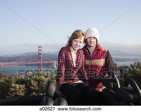 USA, California, San Francisco, young couple sitting, Golden Gate Bridge in background View Large Photo Image Stock Photo - USA, California, San Francisco, young couple sitting, Golden Gate Bridge in background. Fotosearch