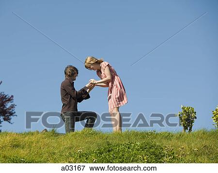 USA, California, San Francisco, young man proposing to girlfriend on hill View Large Photo Image Stock Photo - USA, California, San Francisco, young man proposing to girlfriend on hill. Fotosearch