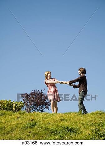 USA, California, San Francisco, young couple holding hands on hill View Large Photo Image Stock Photograph - USA, California, San Francisco, young couple holding hands on hill. Fotosearch