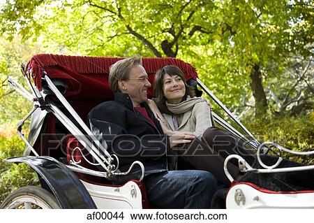 Picture - USA, New York City, Manhattan, Central Park, Mature couple in carriage in Central Park. Fotosearch