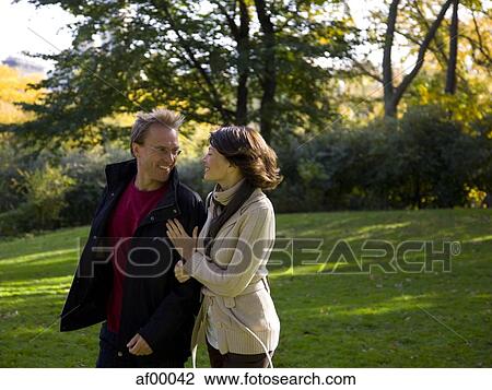 Stock Image - USA, New York City, Manhattan, Central Park, Mature couple in Central Park. Fotosearch