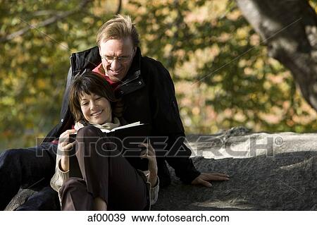 USA, New York City, Manhattan, Central Park, Mature couple reading book in Central Park View Large Photo Image Stock Photo - USA, New York City, Manhattan, Central Park, Mature couple reading book in Central Park. Fotosearch