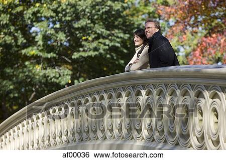 USA, New York City, Manhattan, Central Park, Mature couple standing on bridge in Central Park View Large Photo Image Stock Photograph - USA, New York City, Manhattan, Central Park, Mature couple standing on bridge in Central Park. Fotosearch