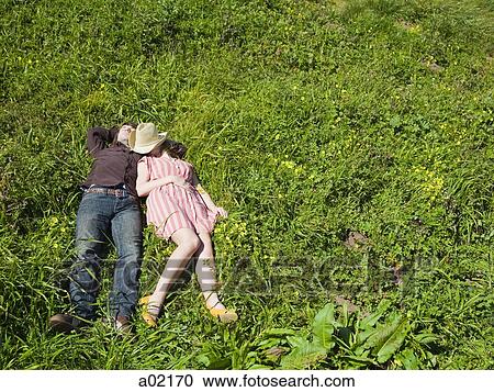 USA, San Francisco, California, young couple lying on grass View Large Photo Image Stock Image - USA, San Francisco, California, young couple lying on grass. Fotosearch