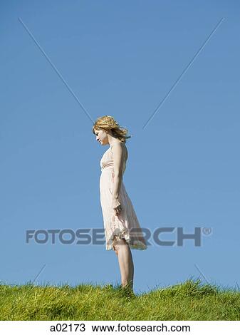 USA, San Francisco, California, young woman standing on grassy hill View Large Photo Image Stock Image - USA, San Francisco, California, young woman standing on grassy hill. Fotosearch