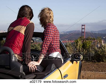 USA, San Francisco, California, young couple sitting in convertible car and looking at Golden Gate Bridge in distance View Large Photo Image Stock Photo - USA, San Francisco, California, young couple sitting in convertible car and looking at Golden Gate Bridge in distance. Fotosearch