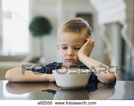 USA, Utah, Alpine, boy (6-7) resting cheek on hand by bowl View Large Photo Image Stock Photography - USA, Utah, Alpine, boy (6-7) resting cheek on hand by bowl. Fotosearch