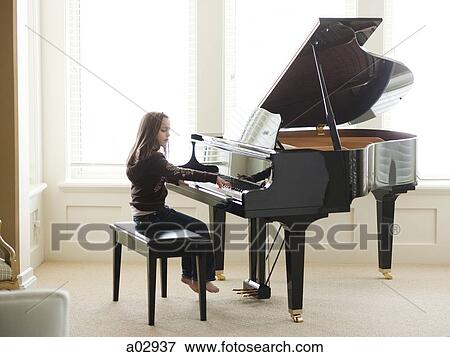 USA, Utah, Alpine, girl (8-9) practicing piano View Large Photo Image Stock Photo - USA, Utah, Alpine, girl (8-9) practicing piano. Fotosearch