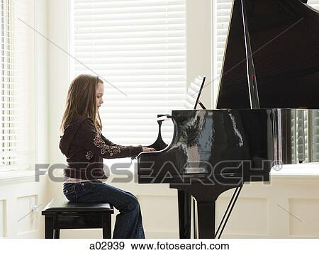 USA, Utah, Alpine, girl (8-9) practicing piano, side view View Large Photo Image Stock Photo - USA, Utah, Alpine, girl (8-9) practicing piano, side view. Fotosearch