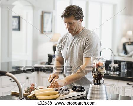 USA, Utah, Alpine, mature man cutting fruits in kitchen View Large Photo Image Stock Photo - USA, Utah, Alpine, mature man cutting fruits in kitchen. Fotosearch