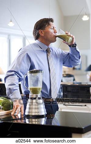 USA, Utah, Alpine, mature man drinking vegetable drink View Large Photo Image Picture - USA, Utah, Alpine, mature man drinking vegetable drink. Fotosearch